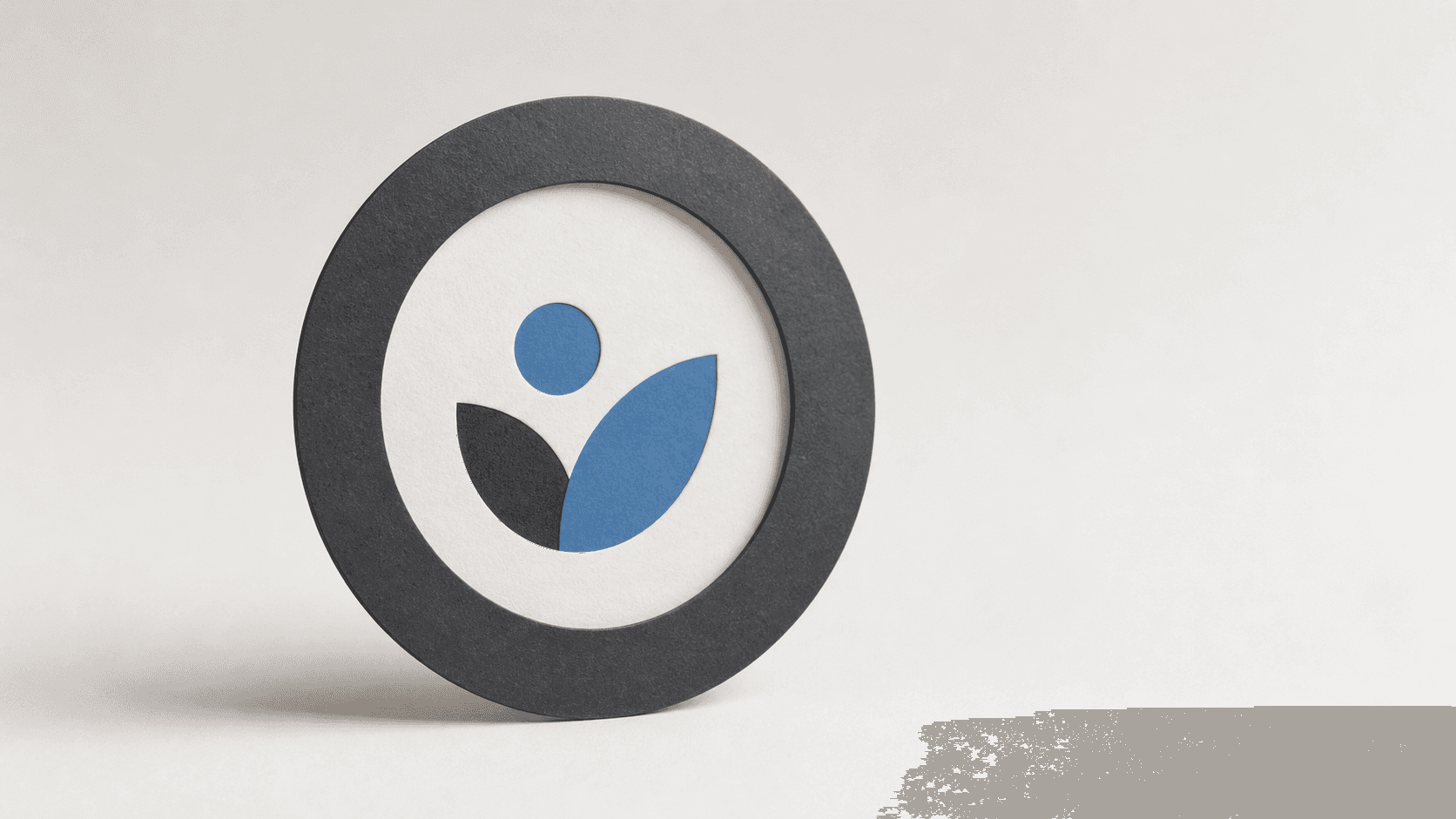 Circular avatar frame with a centered abstract mark on a clean studio background